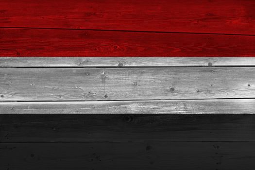 Yemen flag painted on old wood plank. Patriotic background. National flag of Yemen