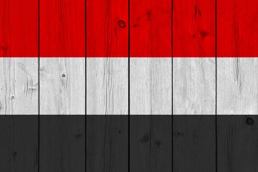 Yemen flag painted on old wood plank. Patriotic background. National flag of Yemen