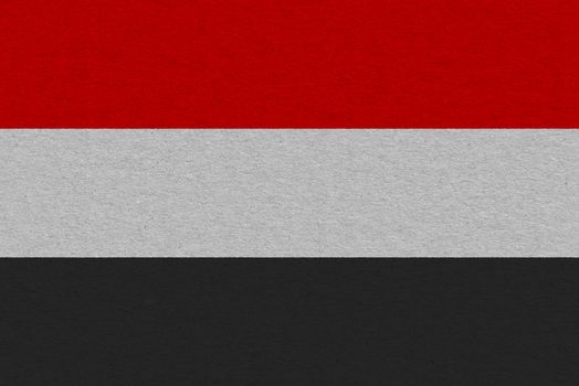 Yemen flag painted on paper. Patriotic background. National flag of Yemen