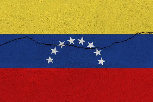 Venezuela flag on concrete wall with crack. Patriotic grunge background. National flag of Venezuela