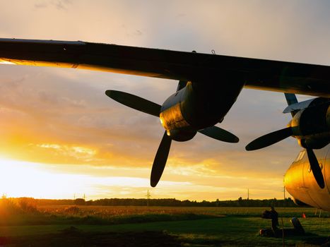 old Soviet military airplane, sunset time. Abandoned Historic Aircraft in Estonia AN-12. Close up of propeller engine. Copy space