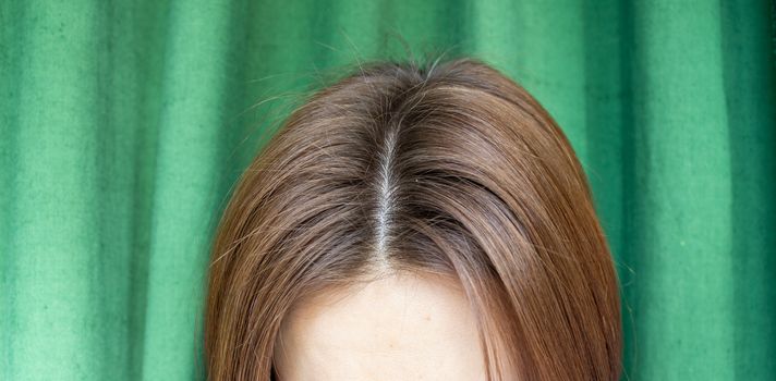 Women's hair after washing on a green background. the view from the top. 