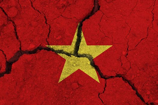Vietnam flag on the cracked earth. National flag of Vietnam. Earthquake or drought concept
