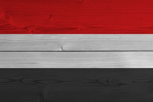 Yemen flag painted on old wood plank. Patriotic background. National flag of Yemen