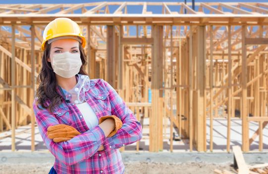 Female Contractor In Hard Hat Wearing Medical Face Mask During Coronavirus Pandemic At Construction Site.