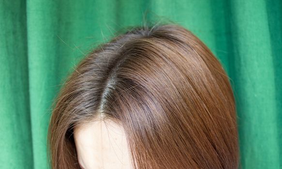 Women's hair after washing on a green background. the view from the top. 