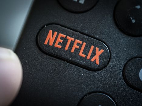 Extreme close up on Netflix remote control tv button