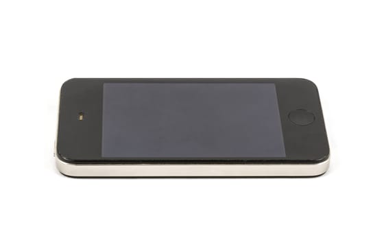 Modern smartphone with blank black screen, lies on the surface, isolated on white background