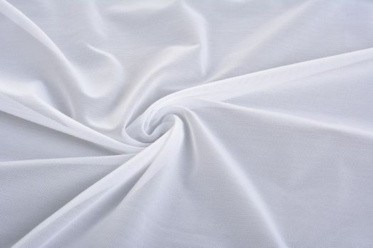 white Knitted elastic fabric, weaving of threads texture, curl crumpled fold. For underwear, sports clothes and swimwear. Space for text.
