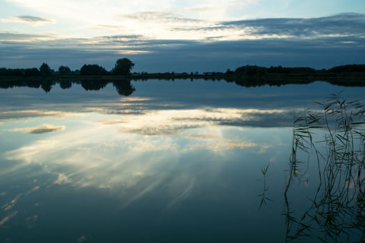 The reflection of clouds in the surface of the lake, evening view
