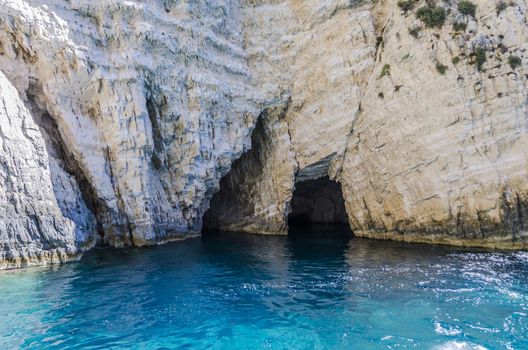 caves and clefts on rocks of a reef on the shores of the island of zakynthos in the ionian sea greece