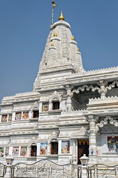 Beautifuly crafted marble dome of Prem Mandir temple in Vrindavan, Mathura, India. It is maintained by Jagadguru Kripalu Parishat, an international non-profit, educational, spiritual, charitable trust. The complex is on a 55-acre site on the outskirts of Vrindavan, and is dedicated to Lord Radha Krishna and Sita Ram, Radha Krishna on the first level and Sita Ram on the second level. The temple structure was established by the fifth Jagadguru, Kripalu Maharaj.Figures of Shri Krishna and his followers depicting important events surrounding the Lord`s existence cover the main temple.