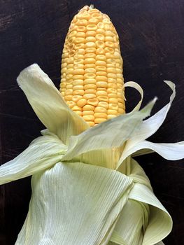 Isolated view of corn maize kept in a plate for cooking after removing the outer skin like leaves
