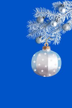 Large silver paper ball on white branch of Christmas tree. Paper art and craft, handmade real paper objects. Christmas and New Year decor. Vertical image. Copy space
