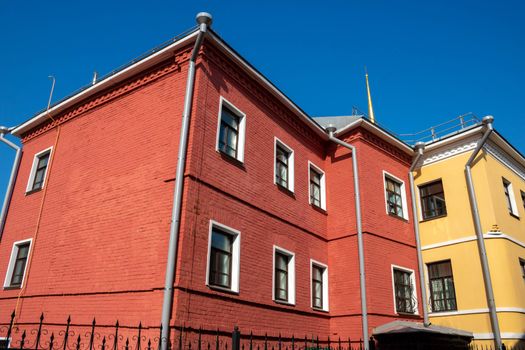 Exterior facade of the red house. Urban vintage background.Bright facades.