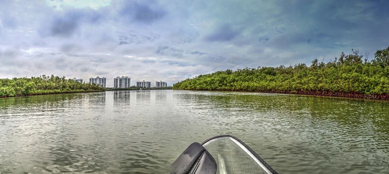 Clear see-through kayak forges its way through the waters of Delnor-Wiggins pass in Bonita Springs, Florida.