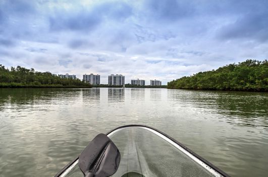 Clear see-through kayak forges its way through the waters of Delnor-Wiggins pass in Bonita Springs, Florida.