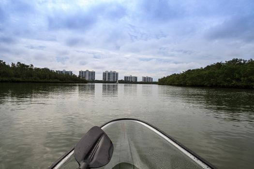 Clear see-through kayak forges its way through the waters of Delnor-Wiggins pass in Bonita Springs, Florida.