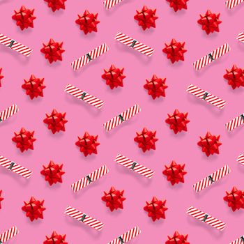 Seamless regular creative Christmas pattern with New Year decorations on pink background. xmas Modern Seamless pattern made from christmas decorations. Photo quality pattern for fabric, prints, wallpapers, banners or creative design works.