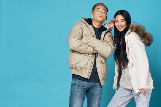 fashionable clothes young people on blue background woman and man asian appearance