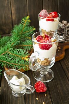 strawberry yogurt with muesli on a black wooden background