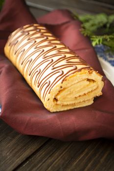 yule log christmas cake on wooden background. Vertical