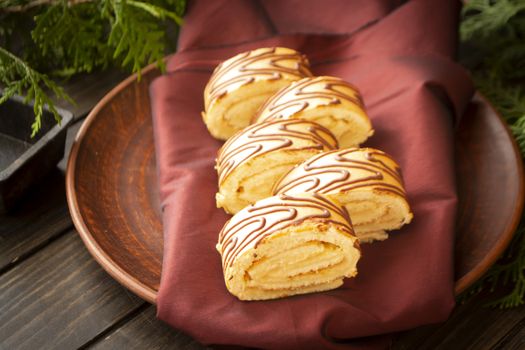 closeup of a yule log cake, traditional of christmas time on a rustic wooden background