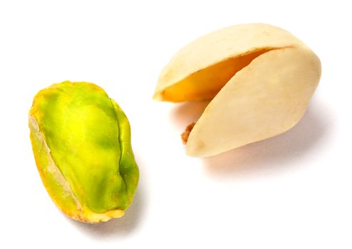 Some Pistachio nuts on a white background