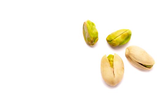 Some Pistachio nuts on a white background