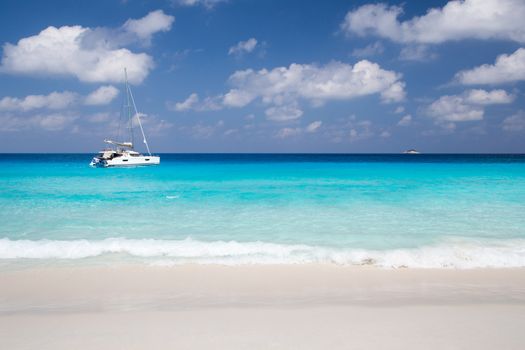 A white sand beach with turqouise water and stones