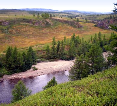 River in the taiga in northern Russia. The nature of the taiga in a mountainous area.