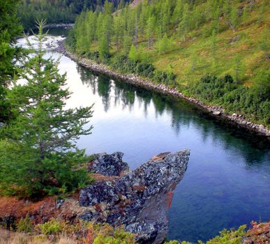 River in the taiga in northern Russia. The nature of the taiga in a mountainous area.