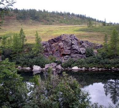 River in the taiga in northern Russia. The nature of the taiga in a mountainous area.