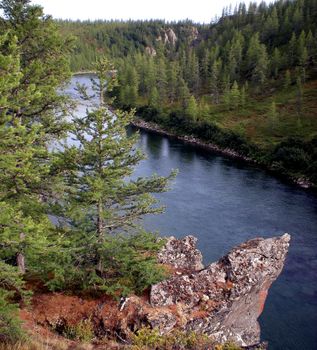 River in the taiga in northern Russia. The nature of the taiga in a mountainous area.