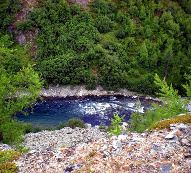 River in the taiga in northern Russia. The nature of the taiga in a mountainous area.