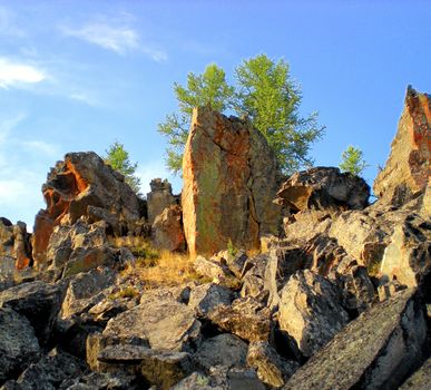 Rocks in the taiga in the Russian north. Exit to the surface of granites and basalts.