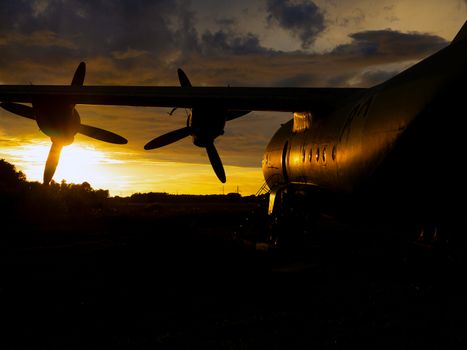 old Soviet military airplane, sunset time. Abandoned Historic Aircraft in Estonia AN-12. Close up of propeller engine. Copy space