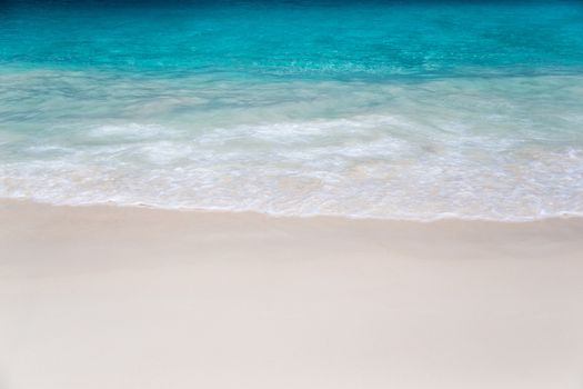 The beach with white sand and turquoise water with waves
