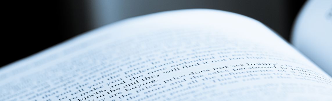 Blue toned macro closeup of an open book, education and studies