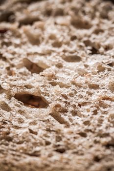 Fresh whole grain seeded bread, organic wheat flour, closeup slice texture as background for food blog or cook book recipes