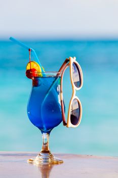 Cocktails, colorful with fruits and sunglasses on the beach