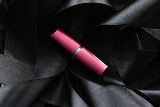 Pink lipstick on black silk background, luxury make-up and beauty cosmetics