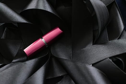 Pink lipstick on black silk background, luxury make-up and beauty cosmetics