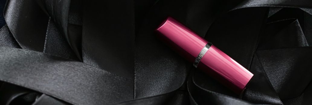 Pink lipstick on black silk background, luxury make-up and beauty cosmetics