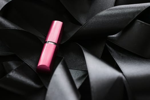 Pink lipstick on black silk background, luxury make-up and beauty cosmetics