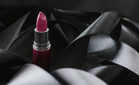 Pink lipstick on black silk background, luxury make-up and beauty cosmetics