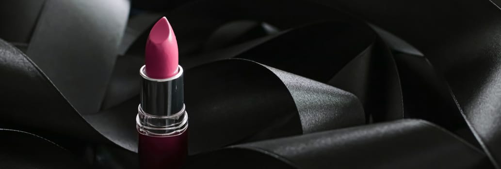 Pink lipstick on black silk background, luxury make-up and beauty cosmetics