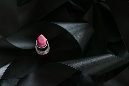 Pink lipstick on black silk background, luxury make-up and beauty cosmetics