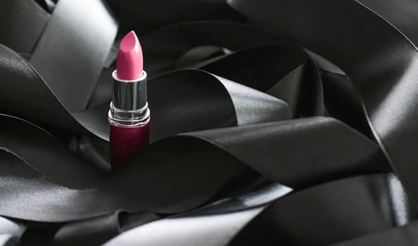 Pink lipstick on black silk background, luxury make-up and beauty cosmetics