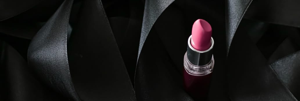 Pink lipstick on black silk background, luxury make-up and beauty cosmetics